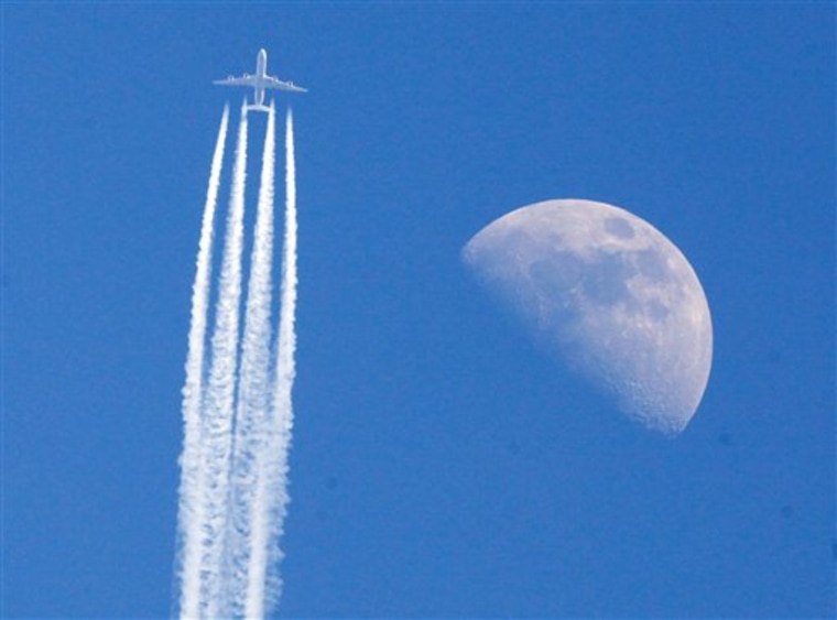 An aircraft passes the moon over Frankfurt, Germany, on April 22 as German air traffic went back to normality following the airspace closure due to the volcanic ash cloud that came from Iceland. 